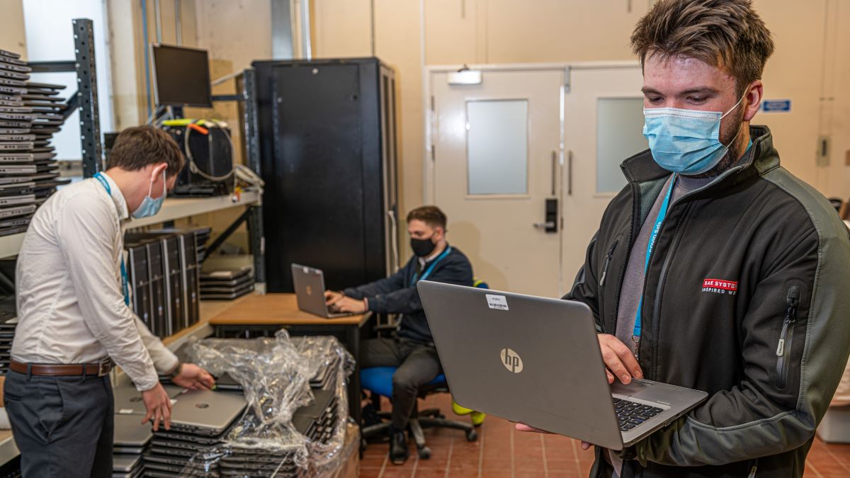 Image of employees organising laptop donations