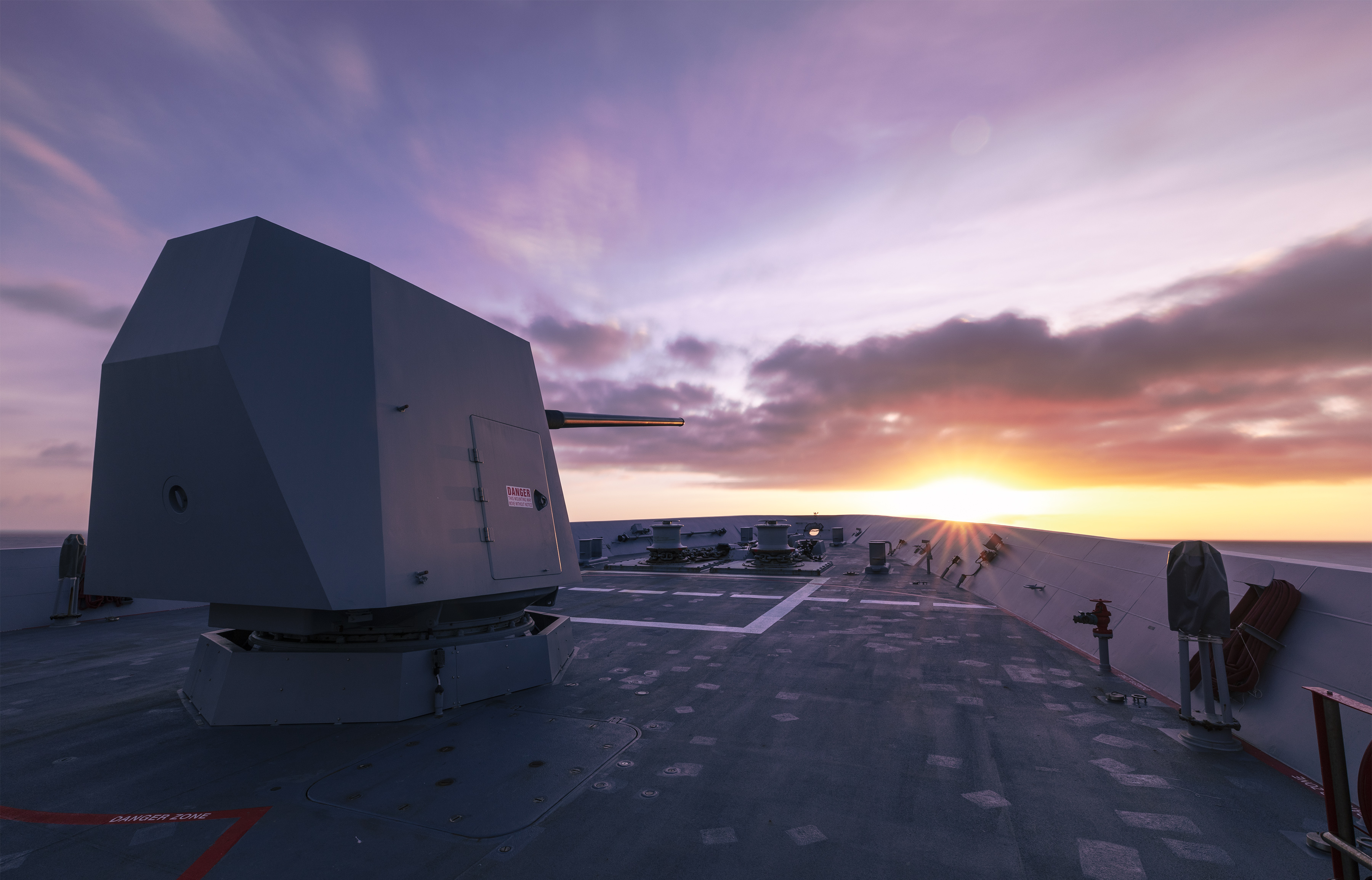 HMAS Brisbane transits through the Gulf of Carpentaria, at sunset as it sails north for an East Asia Deployment