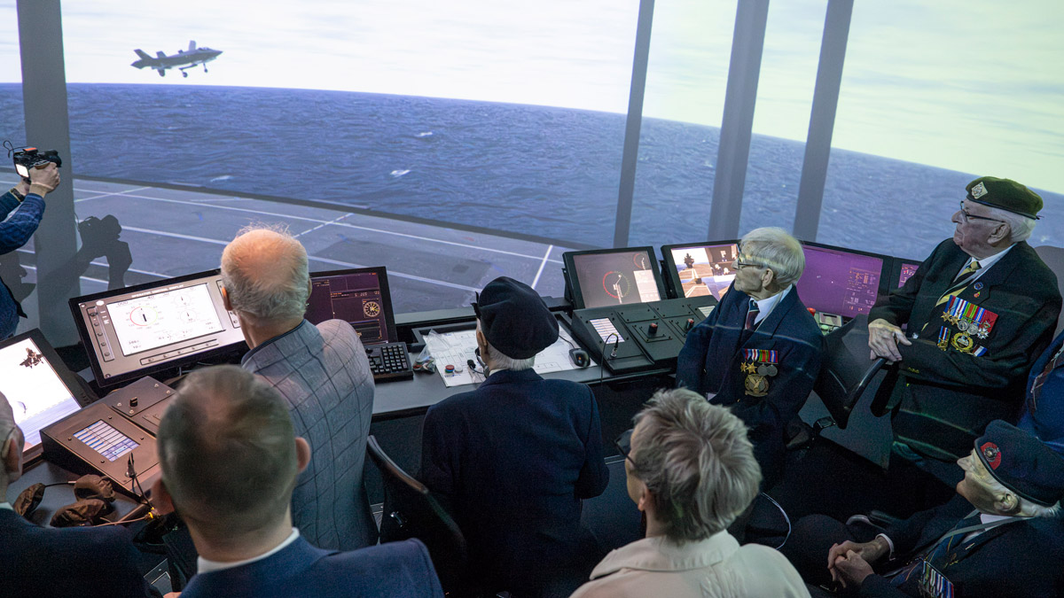 Two volunteers pose for a photo at the Standing with Giants installation between Gold Beach and the British Normandy Memorial in Ver-sur-Mer, France.