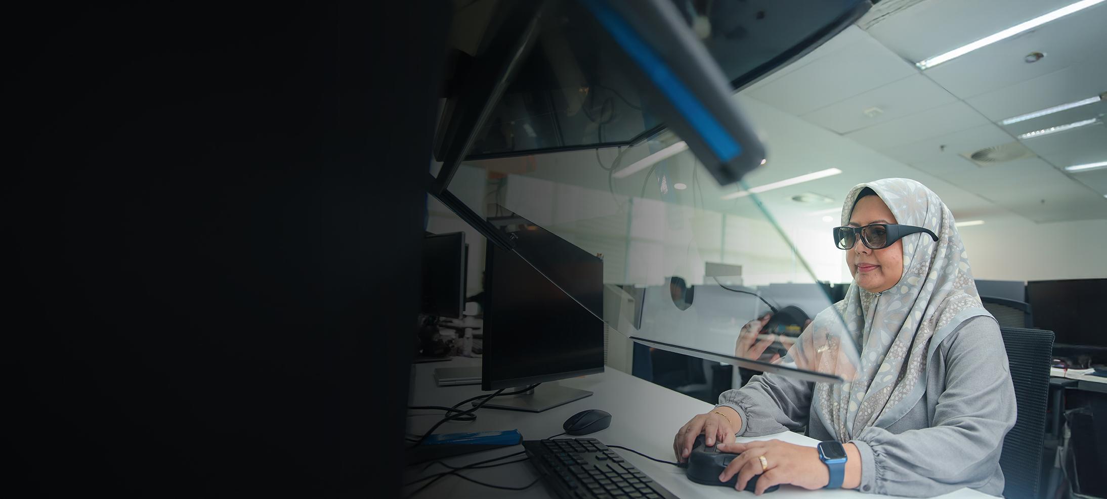 Woman in a cyber security role typing at a desk