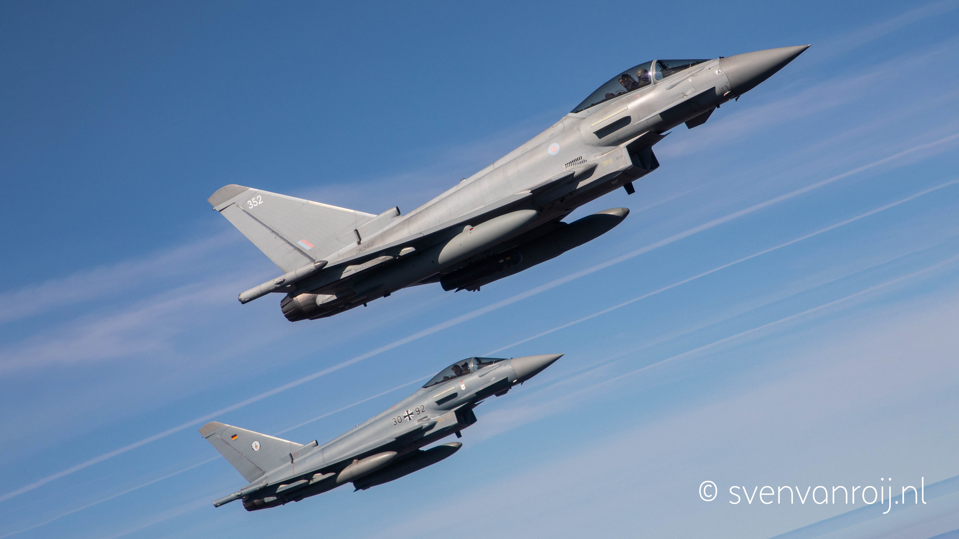Royal Air Force and German Air Force Typhoons flying side by side during NATO Air Policing