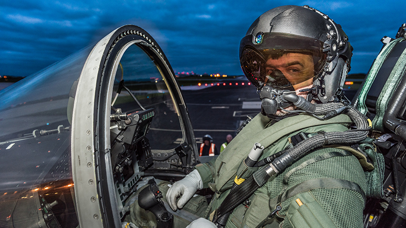 Pilot in cockpit wearing the BAE Systems Striker II digital Helmet-Mounted Display (HMD).