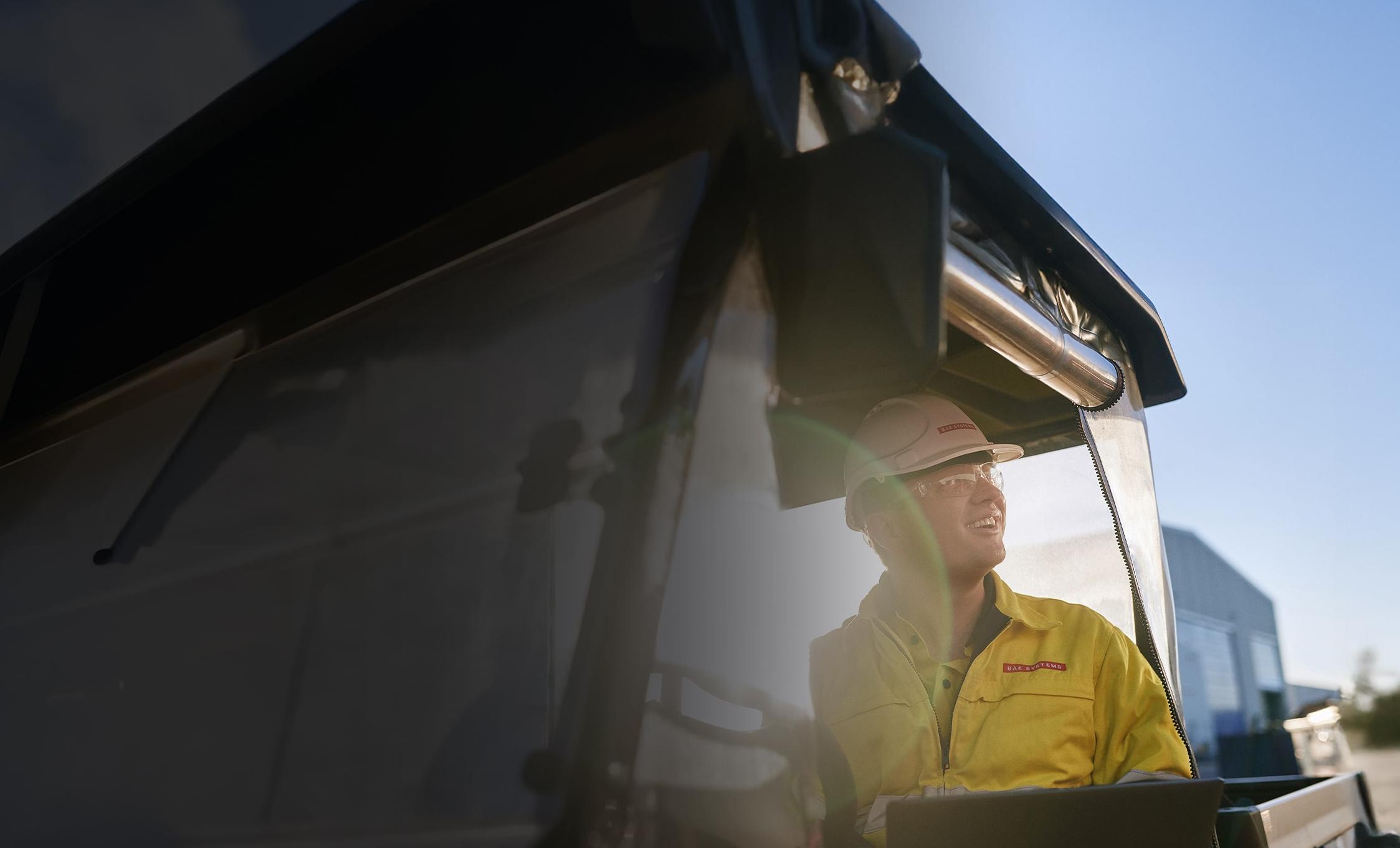 An employee of BAE Systems Australia in a vehicle
