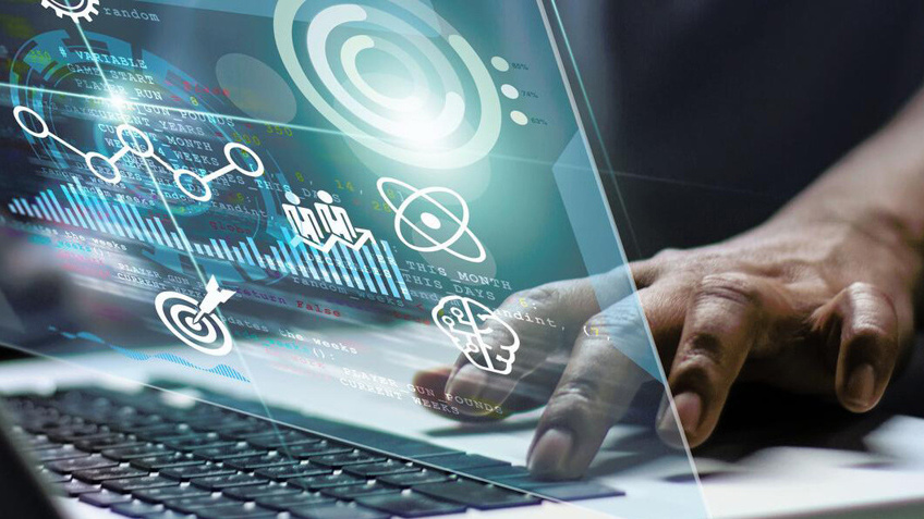 Person typing on computer with holographic display