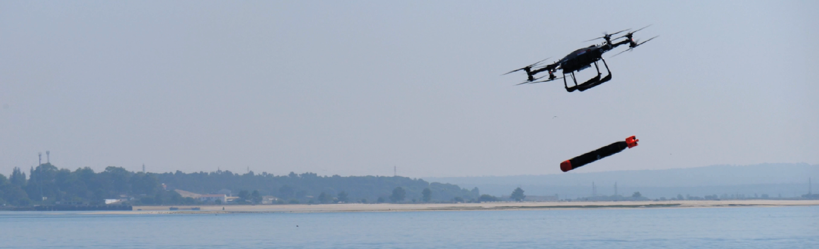 Image of T-600 heavy lift eVTOL demonstrator aircraft releasing a string ray training varient torpedo into the sea at NATO's REPMUS at the Troia Peninsula, Portugal