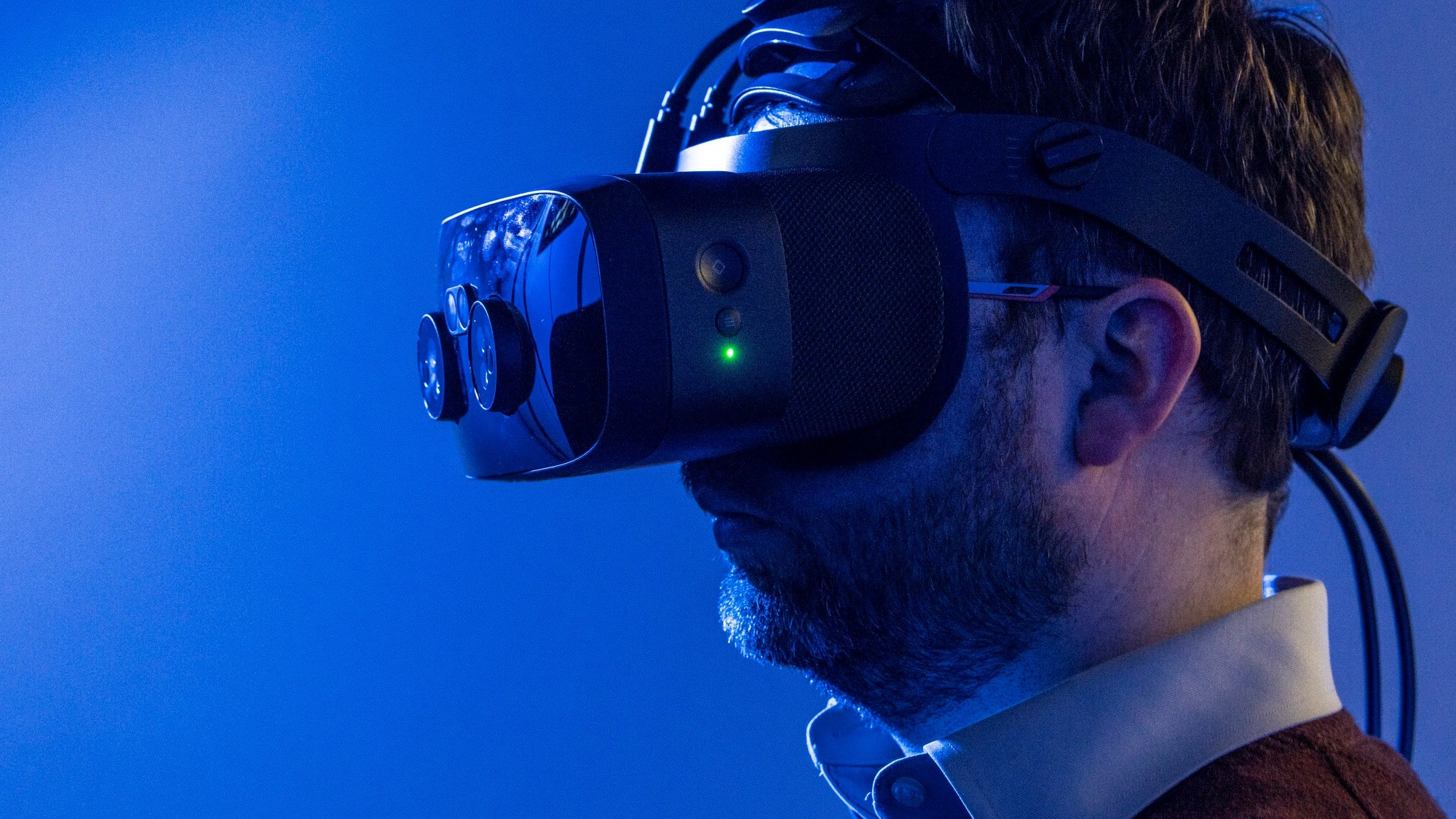 Andrew Batty wears VR headset inside a blue room