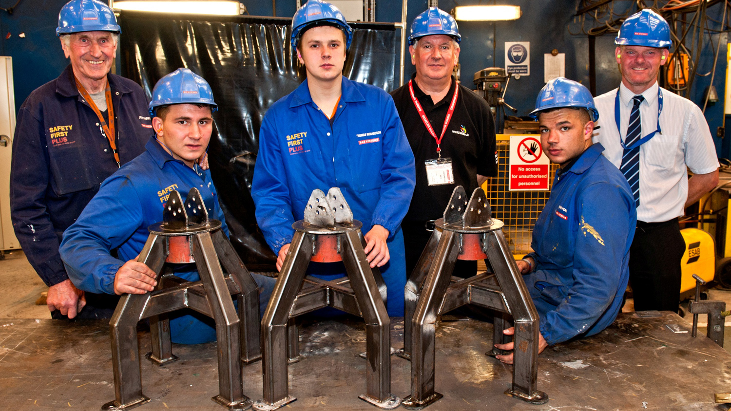 Apprentices with assessors and finished products