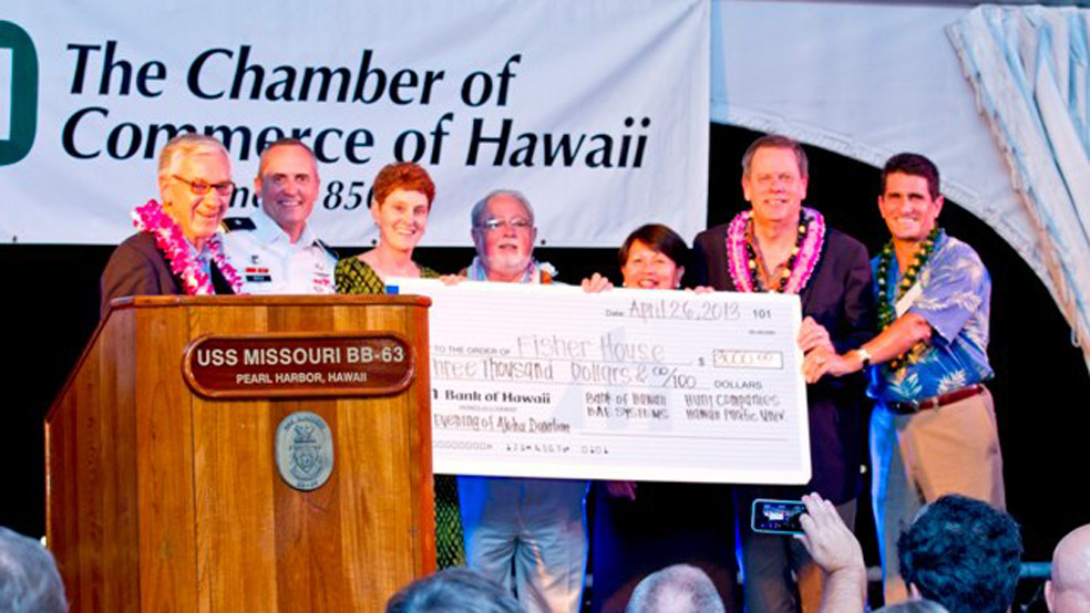 Sponsors of the event presenting the donation to the Fisher House Foundation.