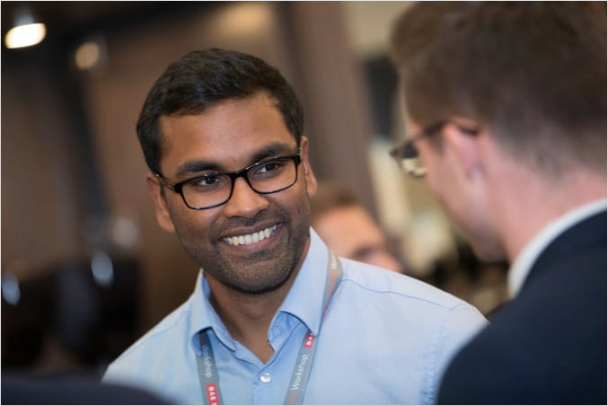 Young men talking at a conference