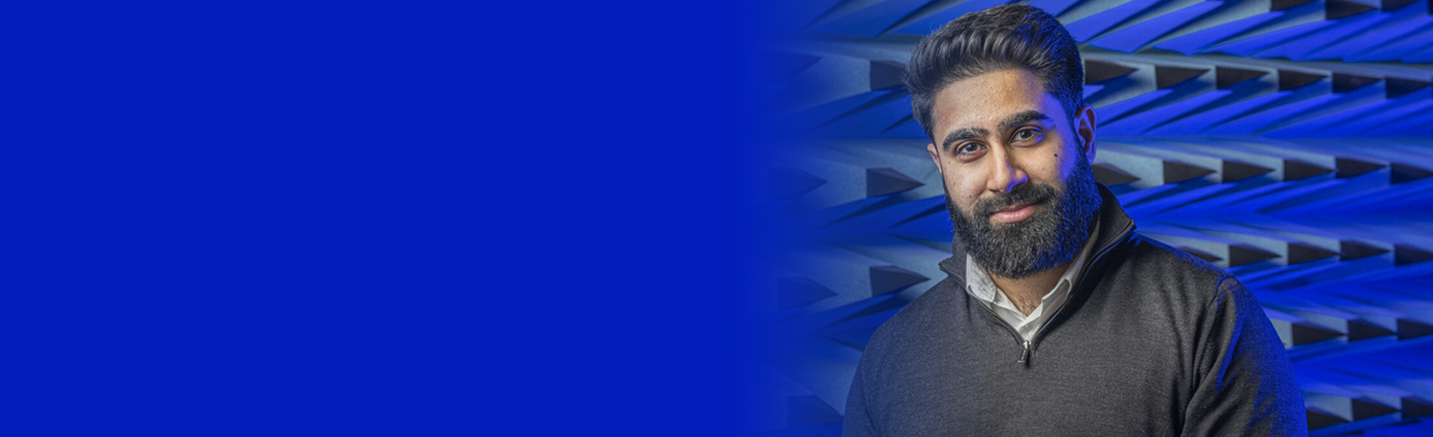 Headshot of Arham smiling in the anechoic testing facility