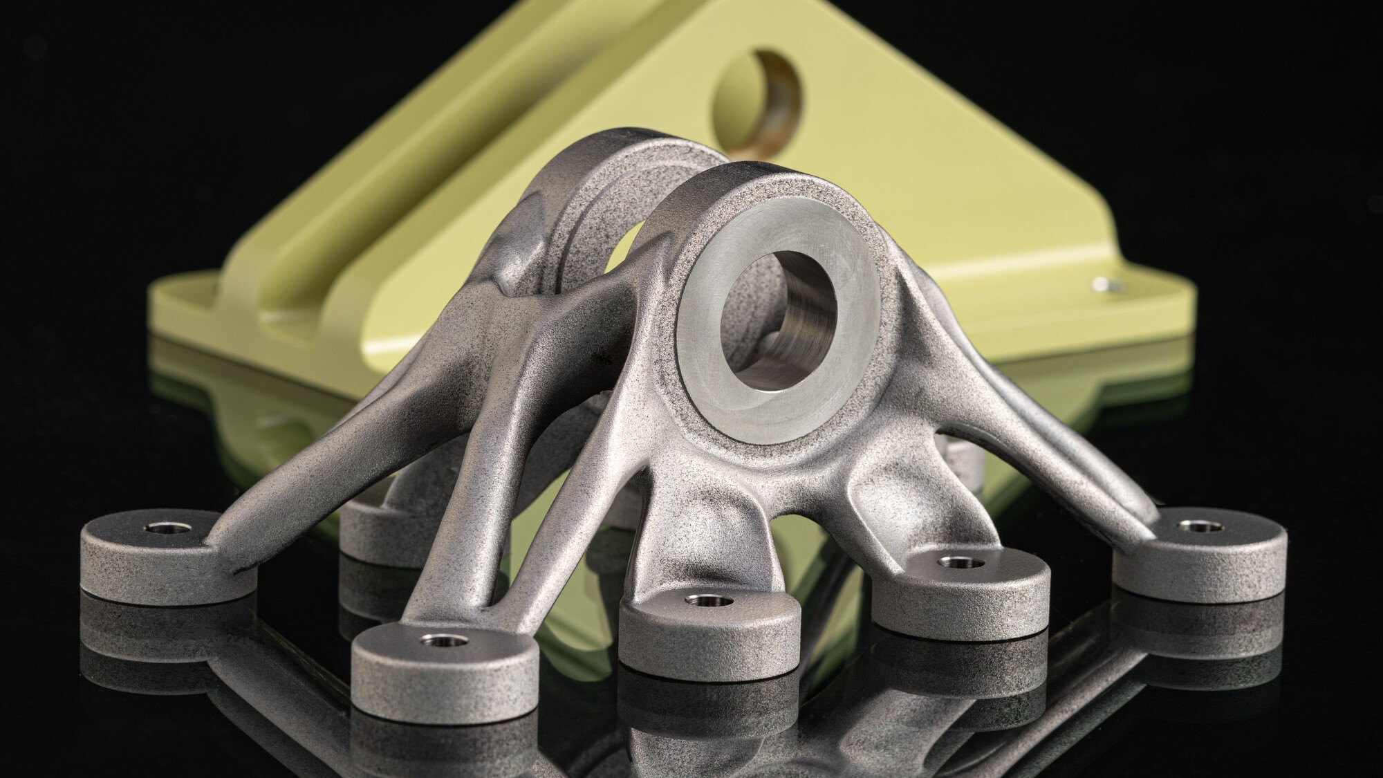 3D printed bracket in front of traditional bracket