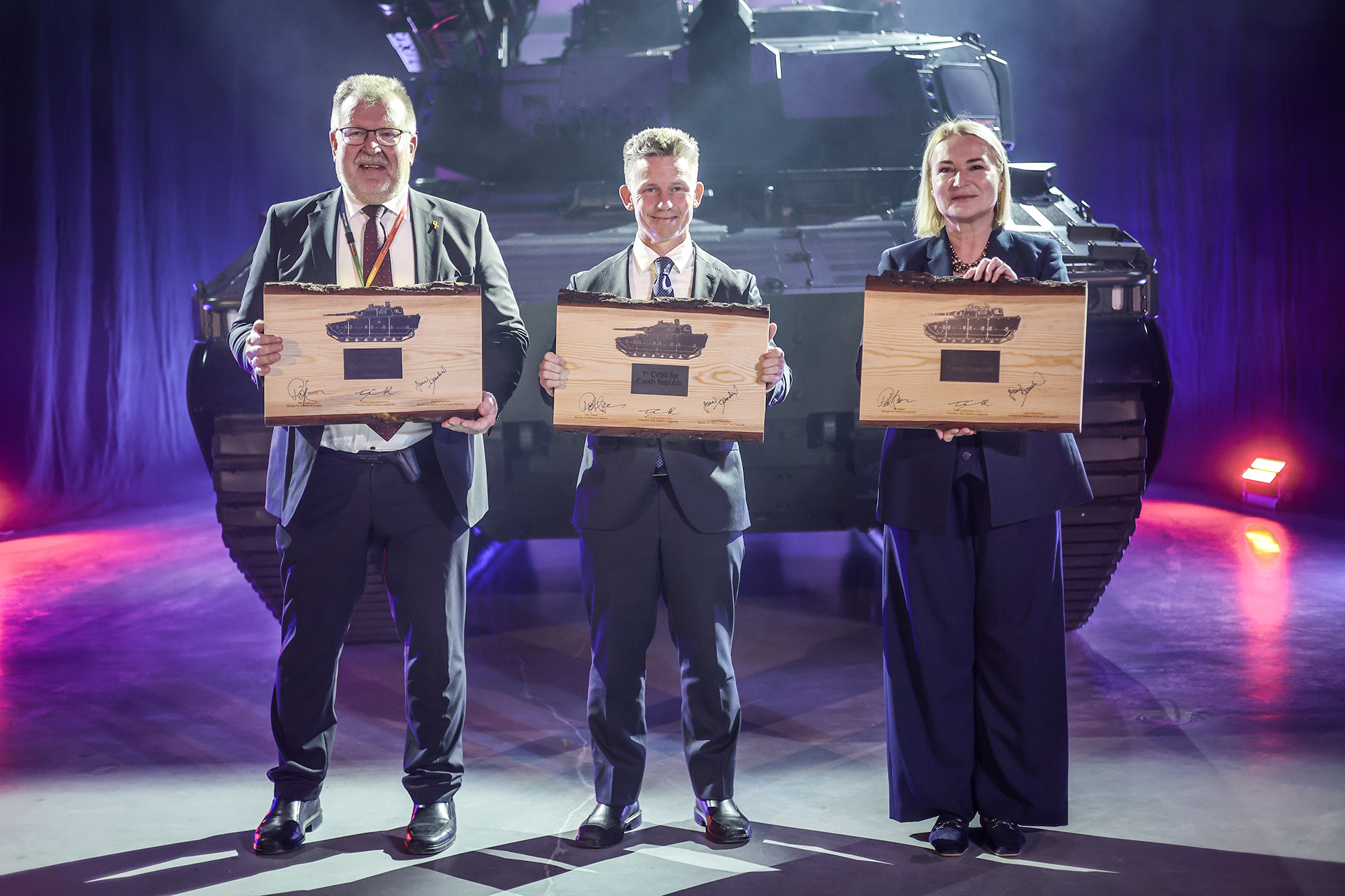 BAE Systems Hägglunds Managing Director Tommy Gustafsson-Rask, Czech Defence Minister Jana Černochová, and Swedish Defence Minister Pål Jonsson mark the milestone with commemorative plaques, standing proudly in front of the first CV9030 MkIV vehicle.