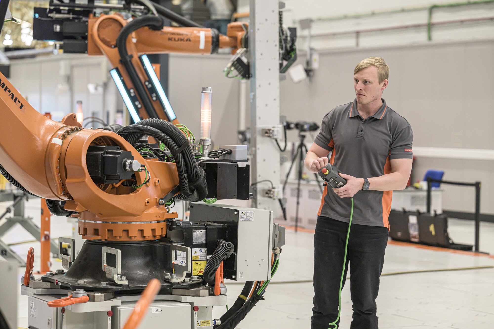A man working with a Kuka robot in the Factory of the Future
