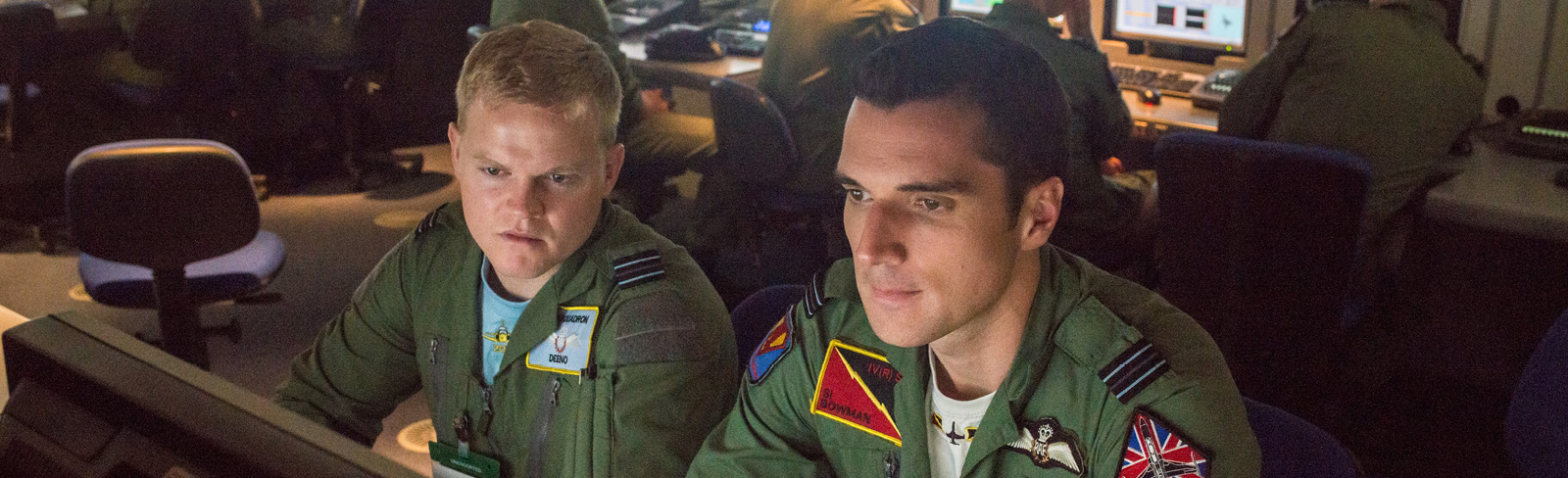 Two air crew study a monitor.