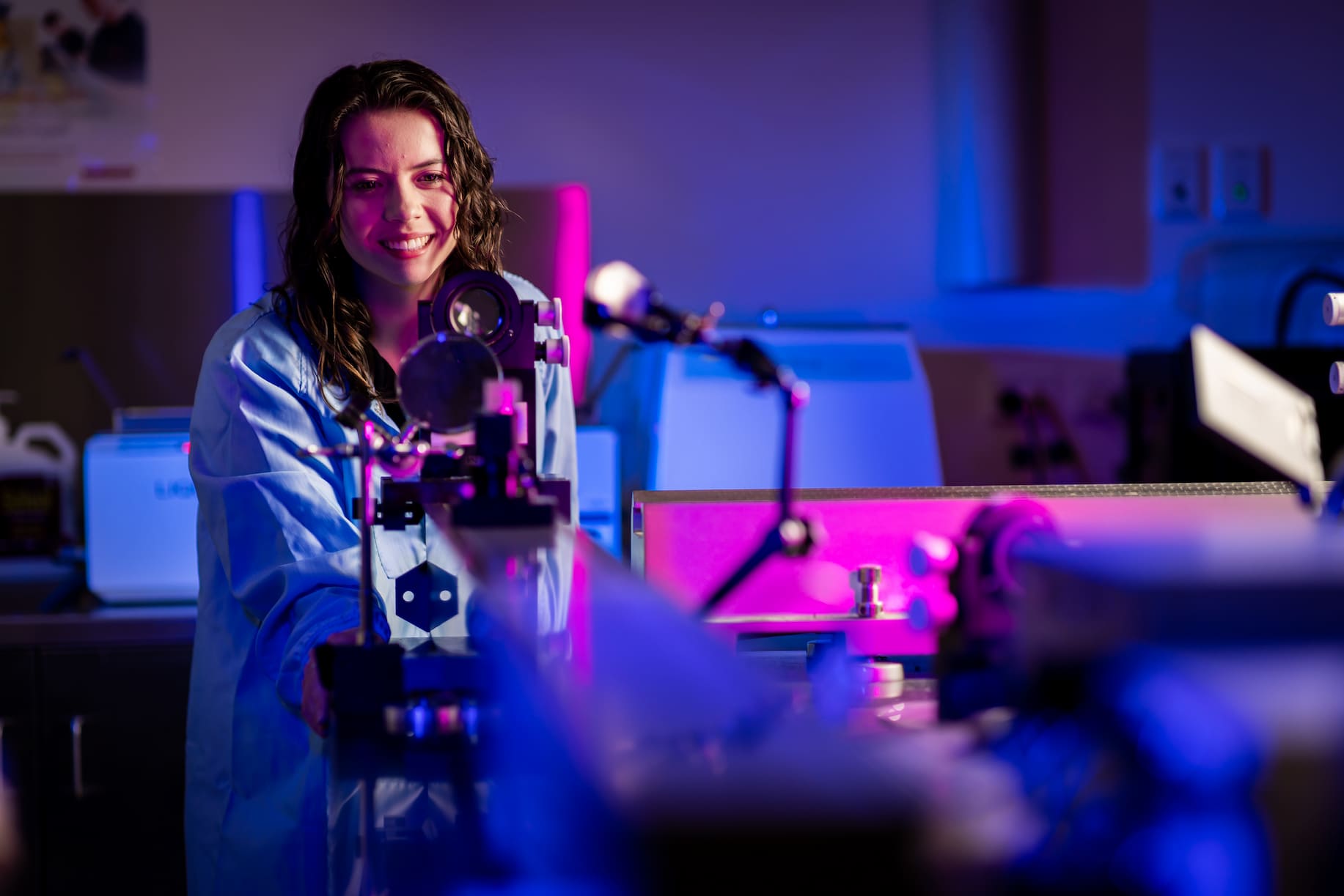 Young woman using complex equipment