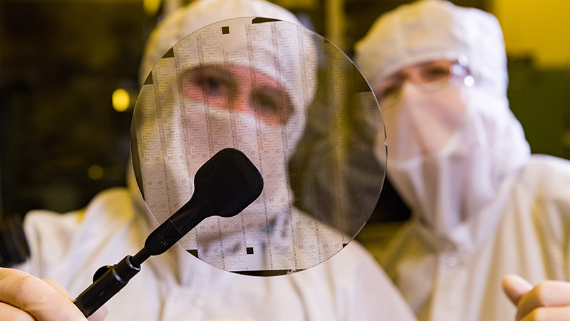 Technicians examine a circuit like those developed at BAE Systems’ Nashua, NH MMIC foundry, who provide GaAs and GaN microelectronics for the U.S. Air Force and others in the U.S. defense community.