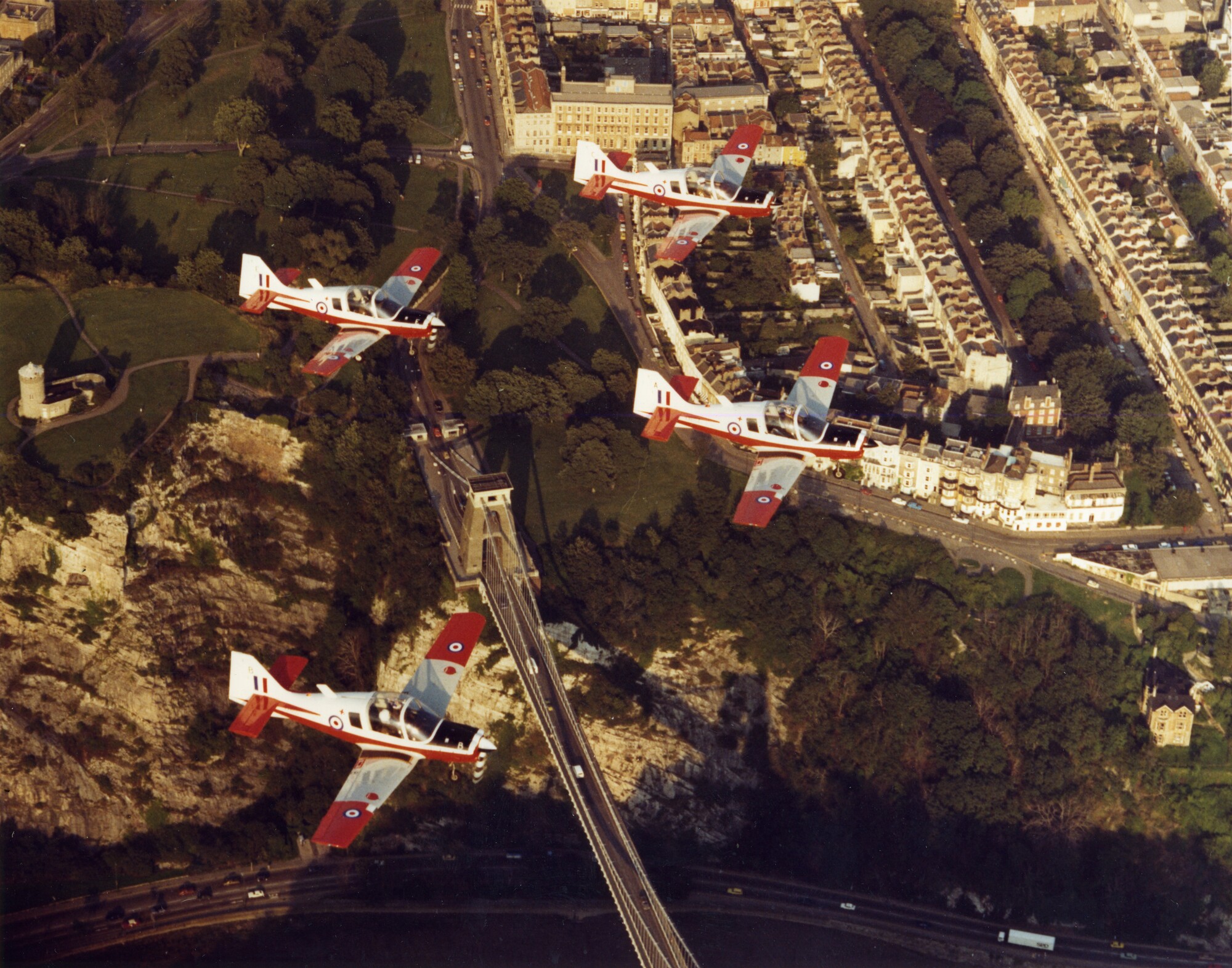 Four RAF Scottish Aviation Bulldog 120s flying in formation over the Bristol Suspension Bridge.