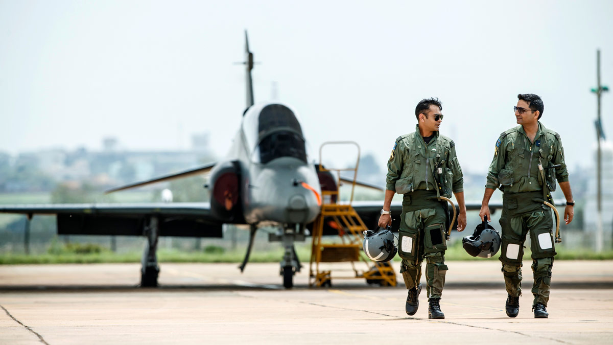 Image of IAF (Indian Air Force) Hawk aircraft with pilots on runway