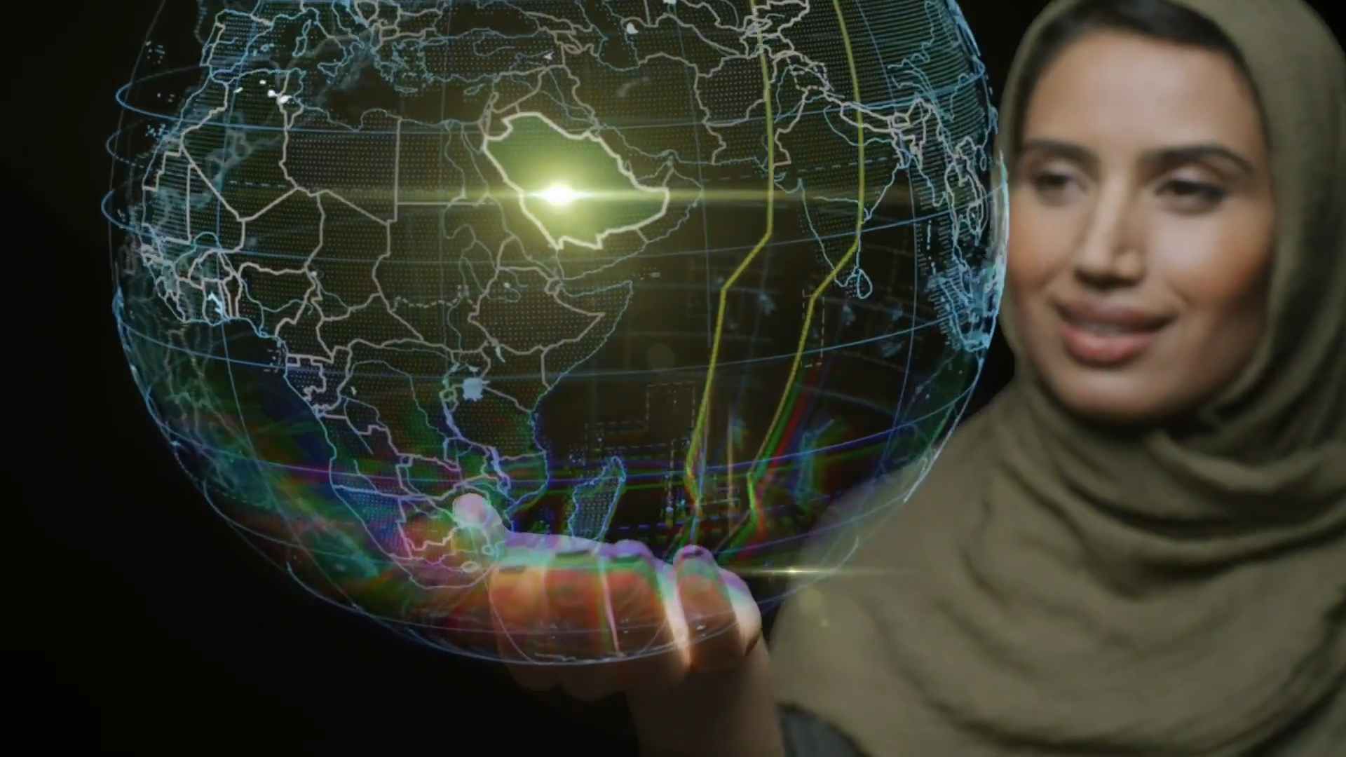 Kingdom of Saudi Arabia highlighted on a digital globe being held by a Saudi woman