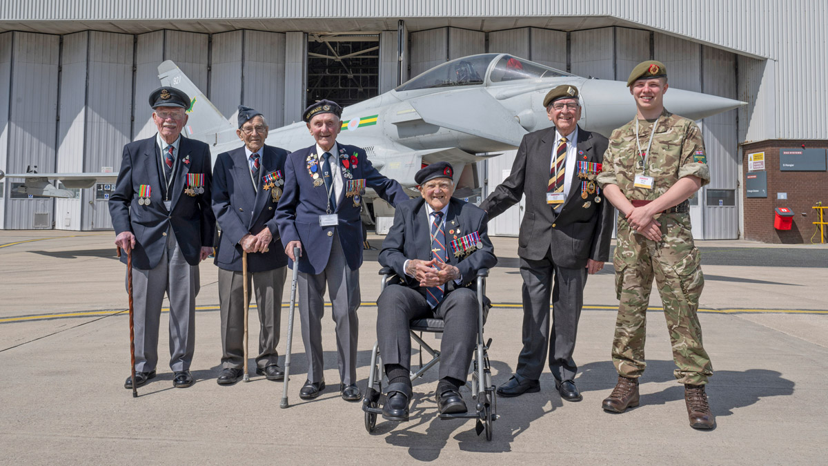 Two volunteers pose for a photo at the Standing with Giants installation between Gold Beach and the British Normandy Memorial in Ver-sur-Mer, France.