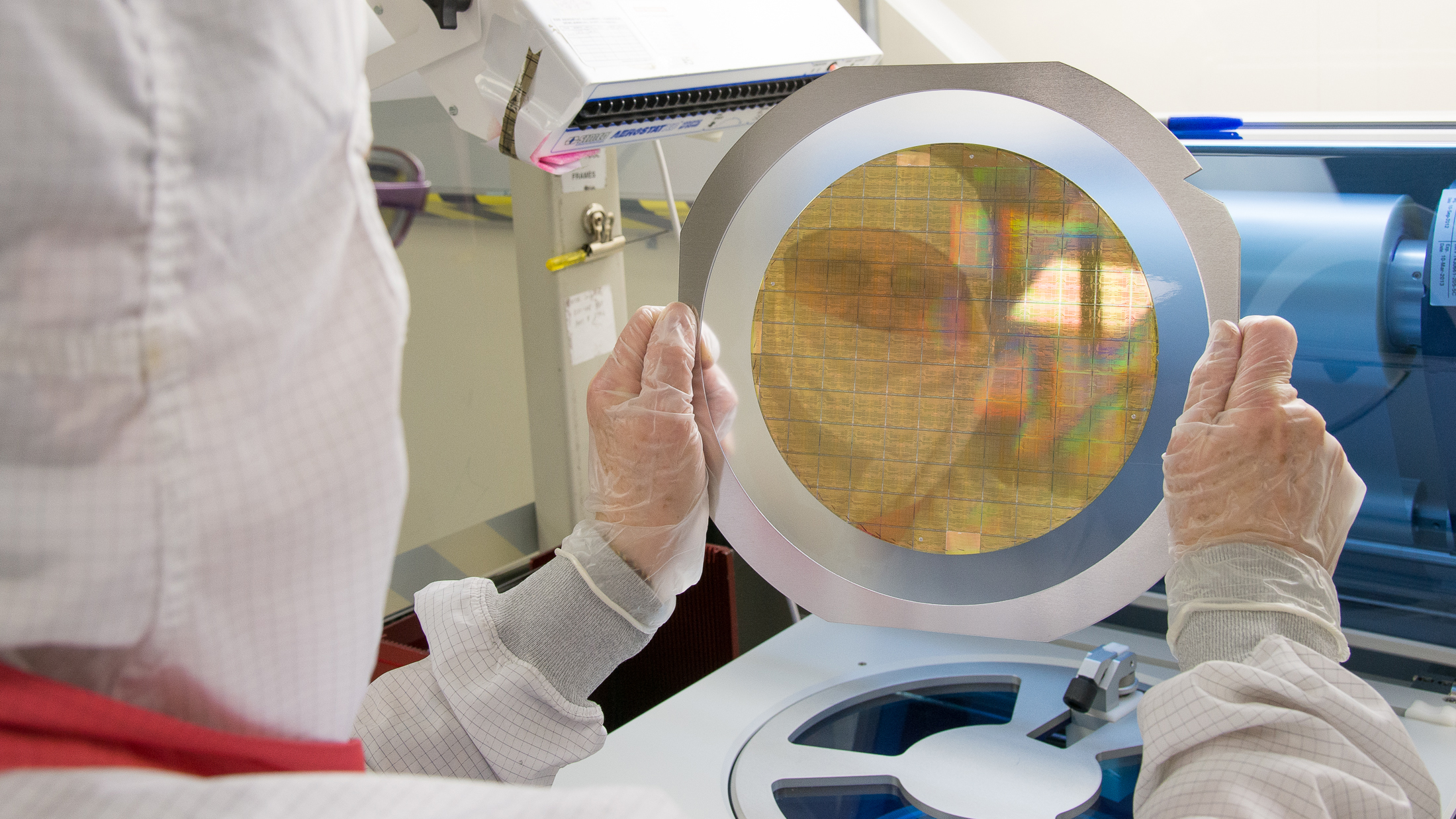 Several Application Specific Integrated Circuits (ASICs) are prepped on a wafer thin slice of semiconductor material for a trip into space.