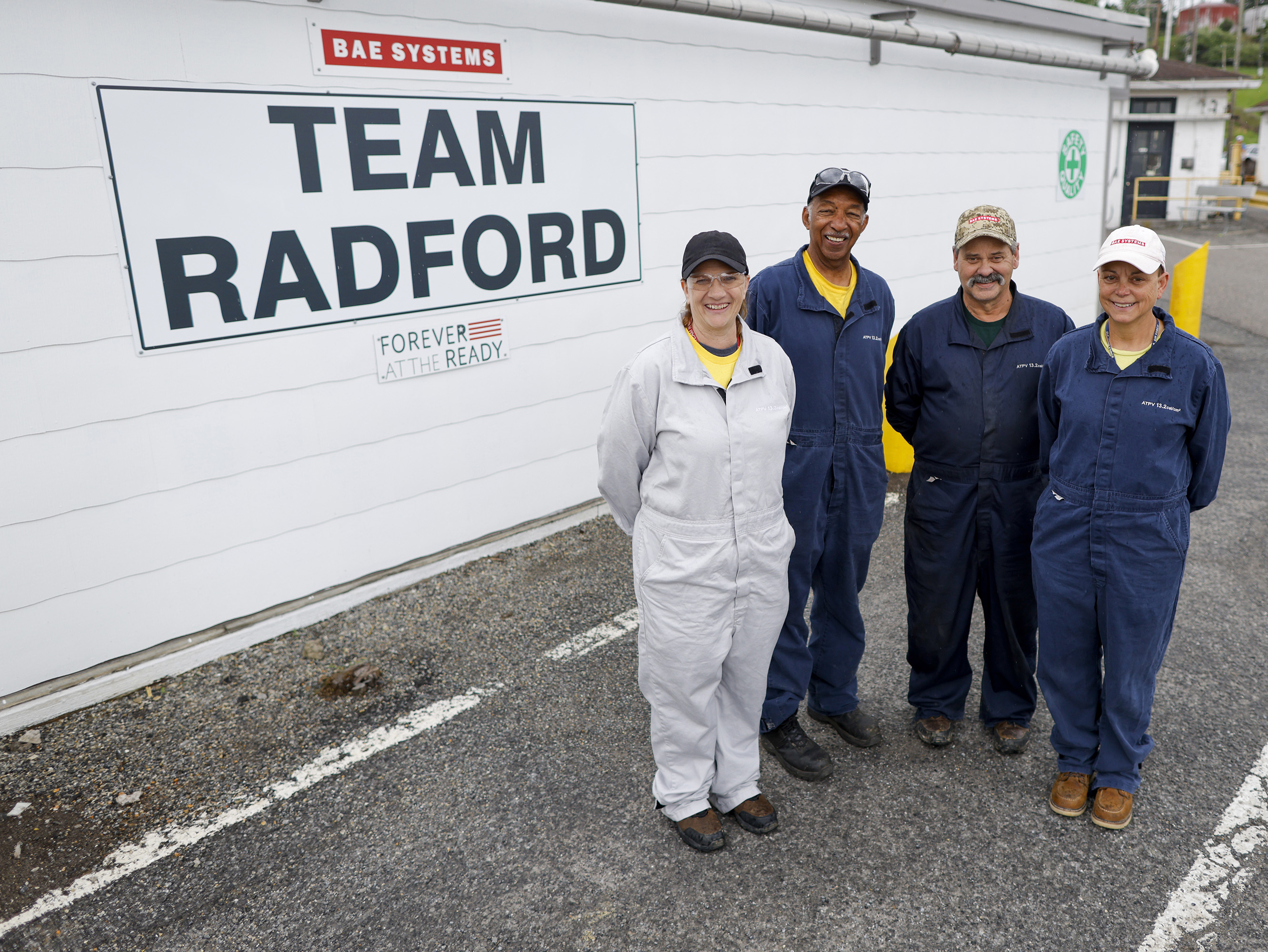 Radford employees in front of "Team Radford" sign