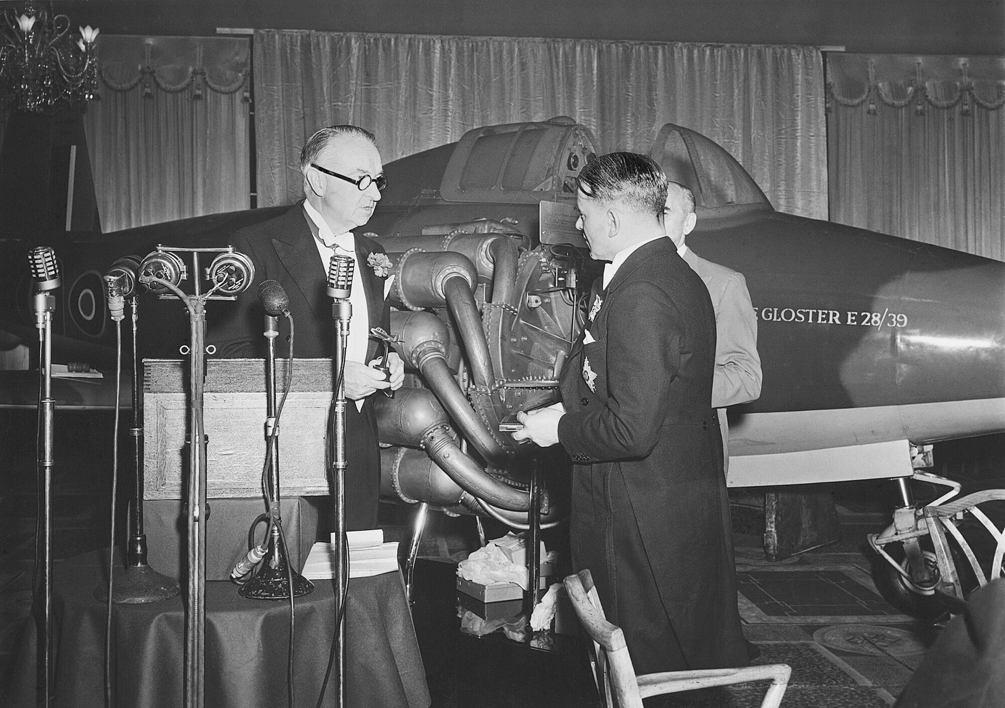 Sir Thomas Sopwith presenting Sir Frank Whittle with a silver replica of the Gloster E28-39 at a dinner at the Dorchester Hotel, London, to celebrate the 10th anniversary of the jet plane, 4th June 1951.