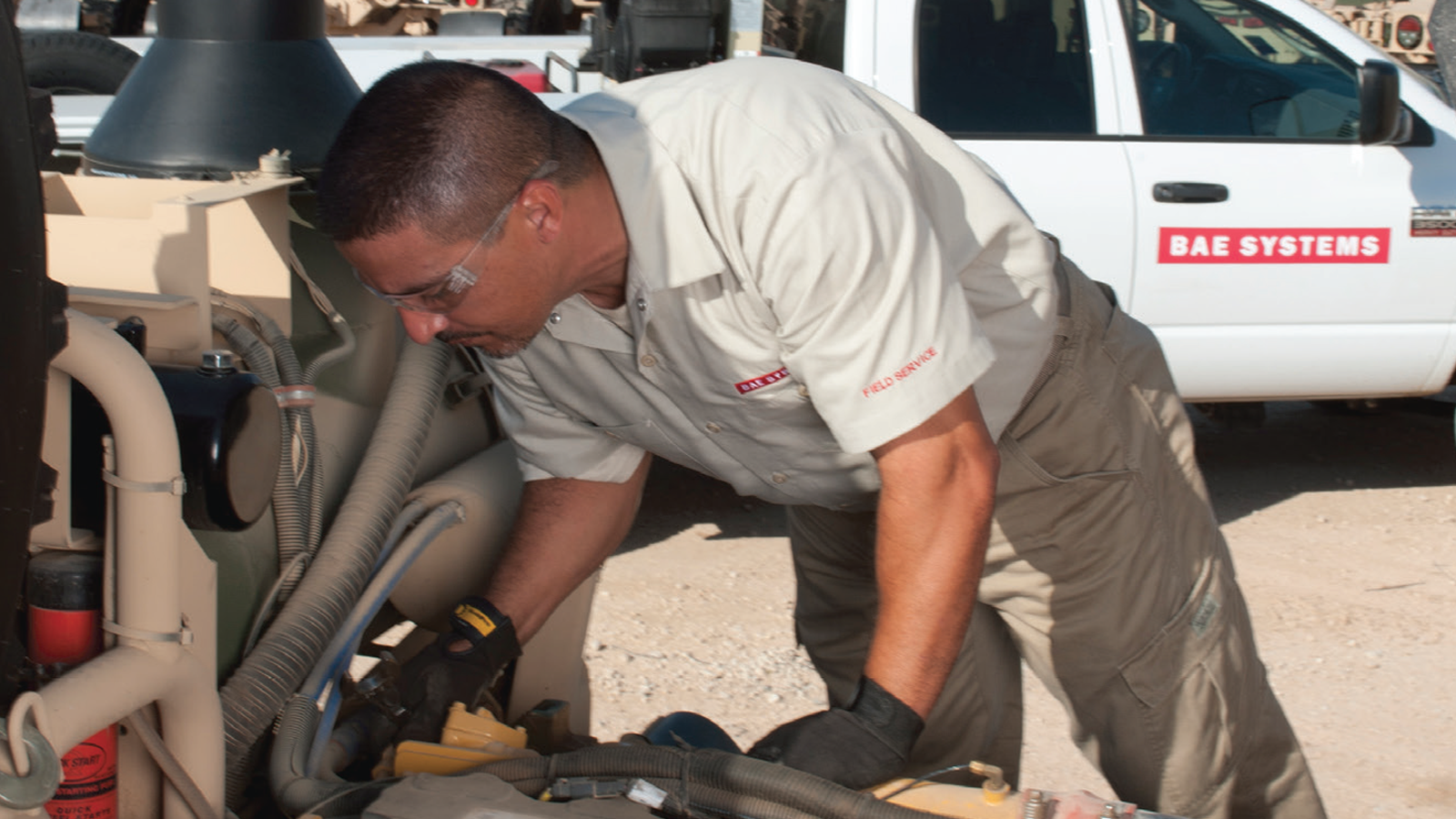 BAE Systems Field Service Rep looking over engine components.