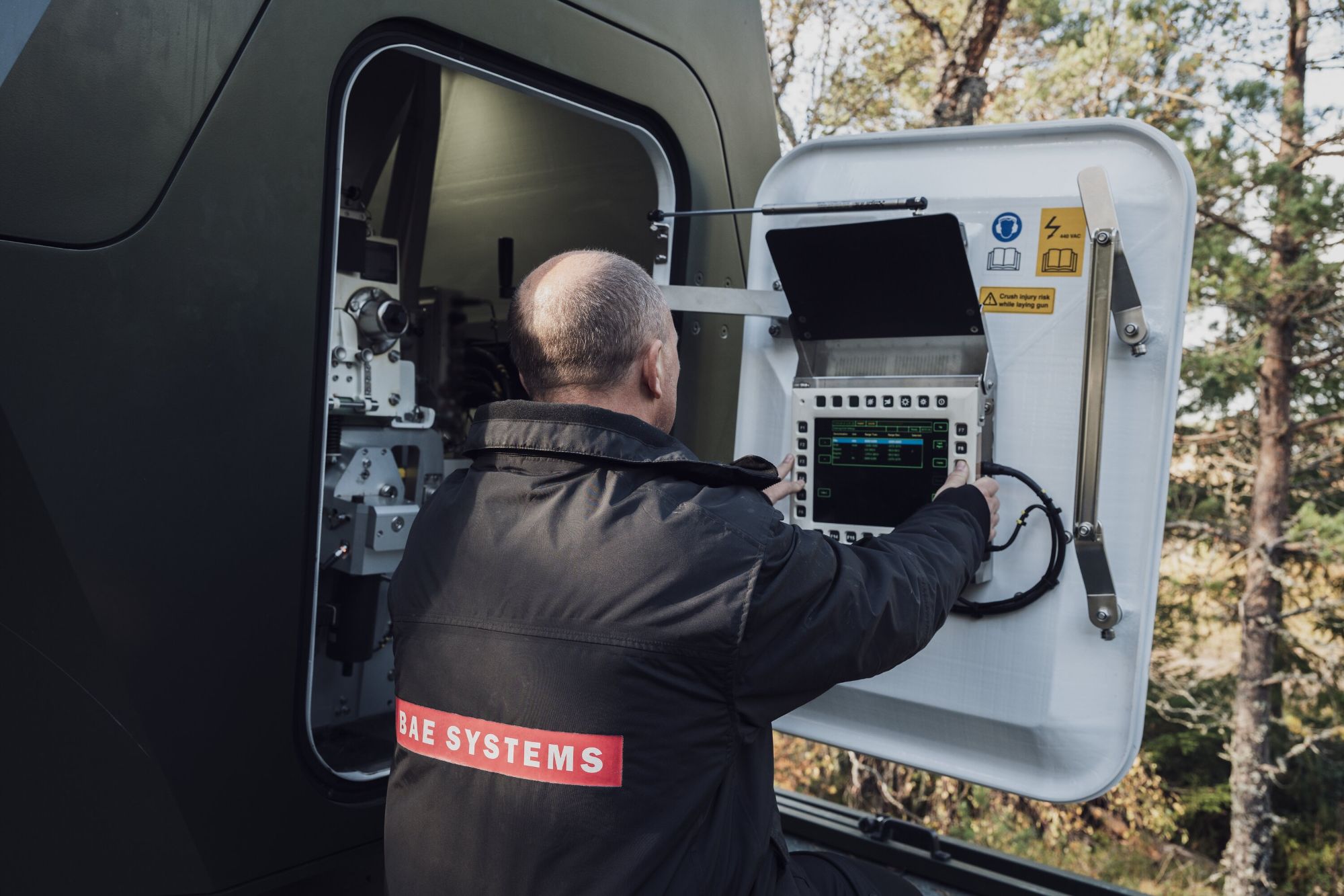 Operator accessing a service panel on the Tridon mobile air defence system.
