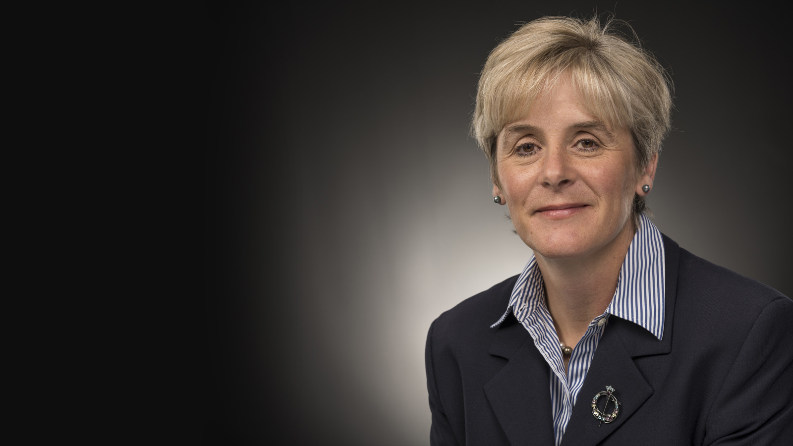 Headshot image of Andrea Thompson with dark background