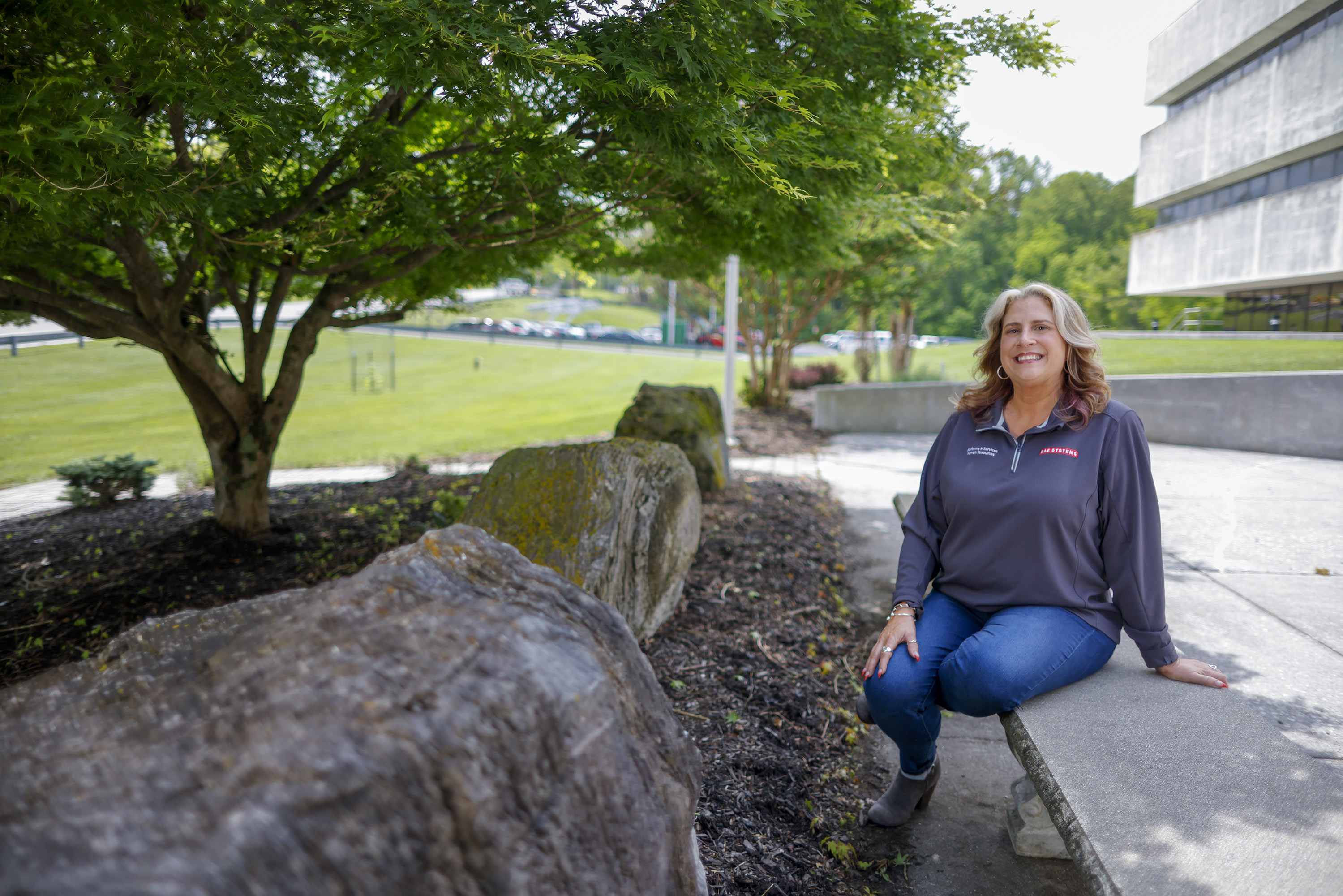 OSI team member sits on bench outside building at Radford Army Ammunition Plant