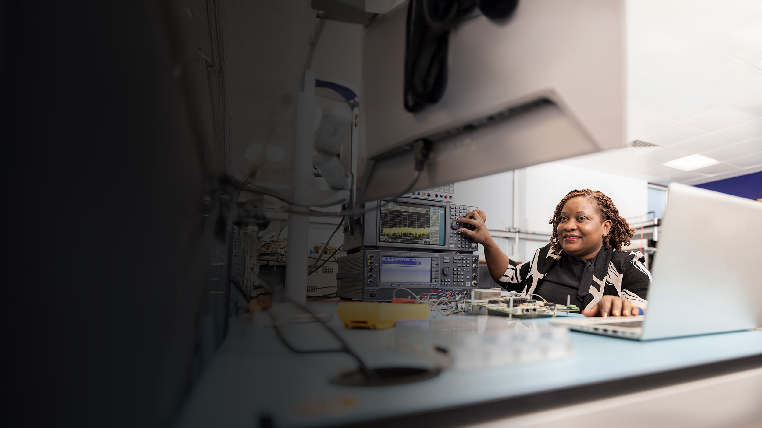 Female employee sitting at desk on laptop