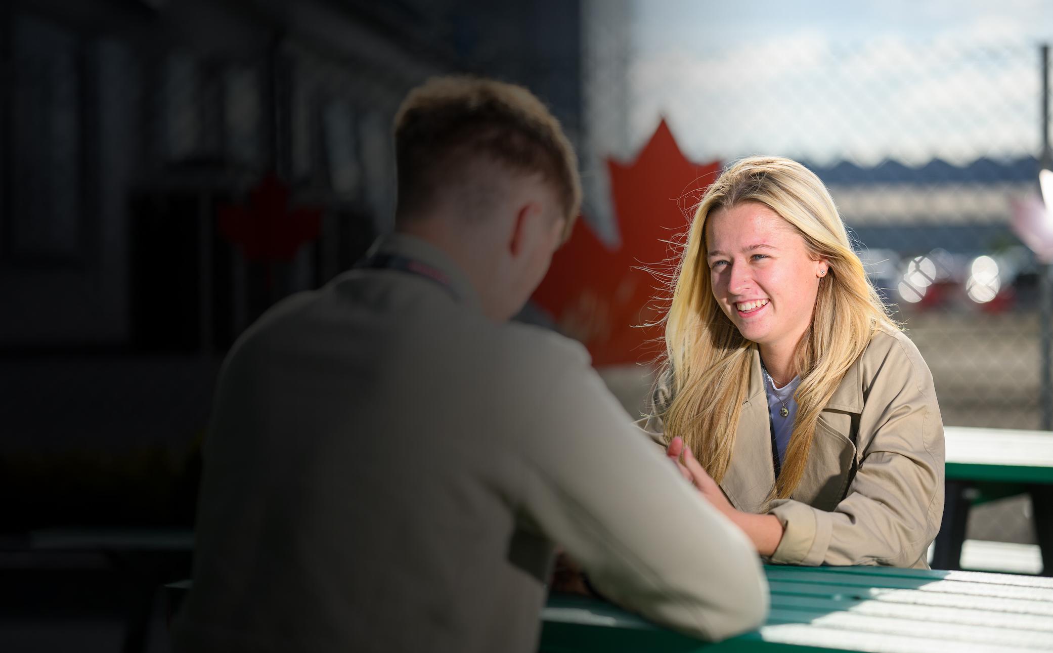 Female talking to male colleague