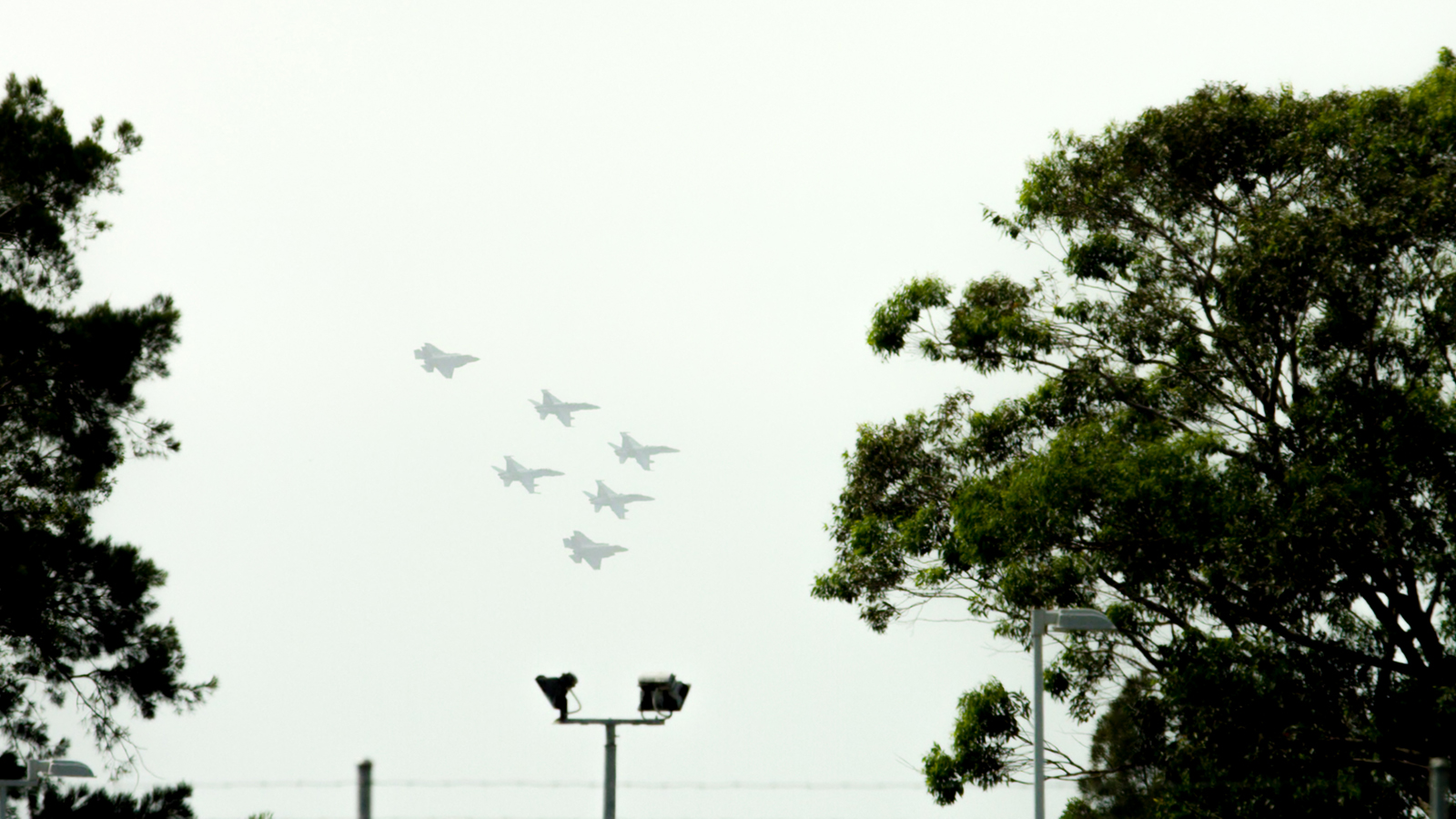 The first F-35 aircraft to arrive at RAAF Base Williamtown in formation with F/A-18 Hornets.