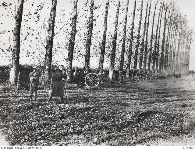 A British official cinematographer filming 'The last shot fired before the Armistice' by a battery of 18-pounder field guns, 11.00 am, 11 November 1918. (IWM Q 3353)
