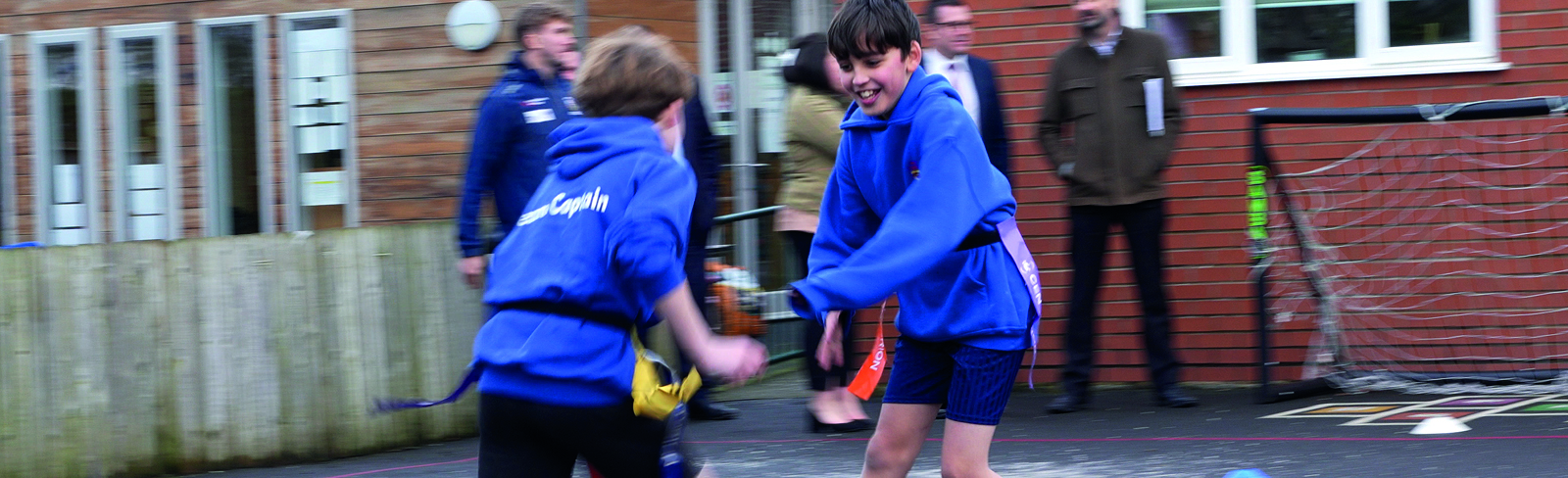 Two boys playing tag rugby