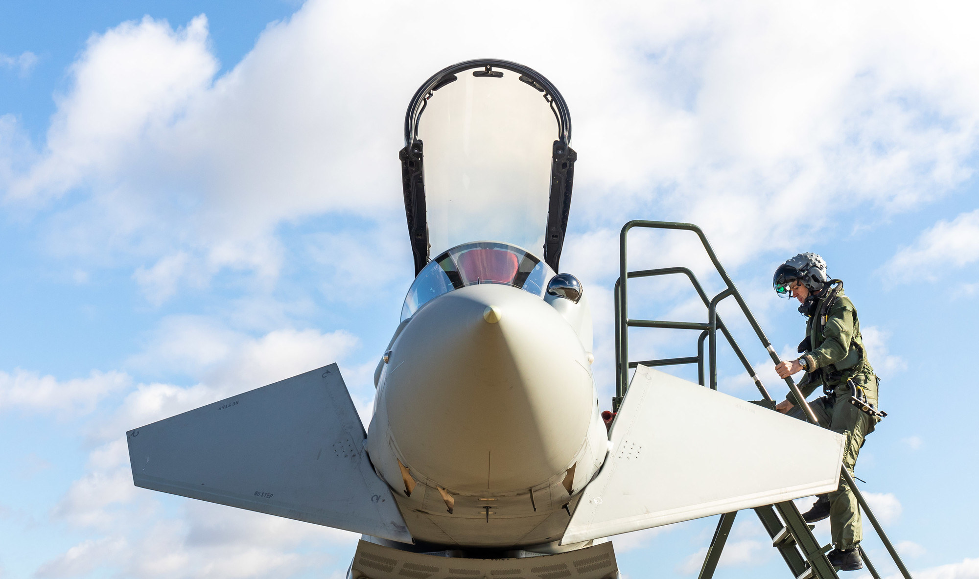 A pilot of 11 Squadron, Royal Air Force with a Typhoon aircraft.