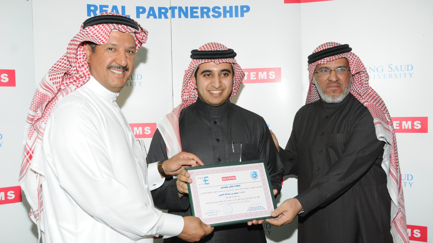 Abdullah Al Kanhal (left) and Dr. Khalid Alhumaizy (right) present an award to an engineering student