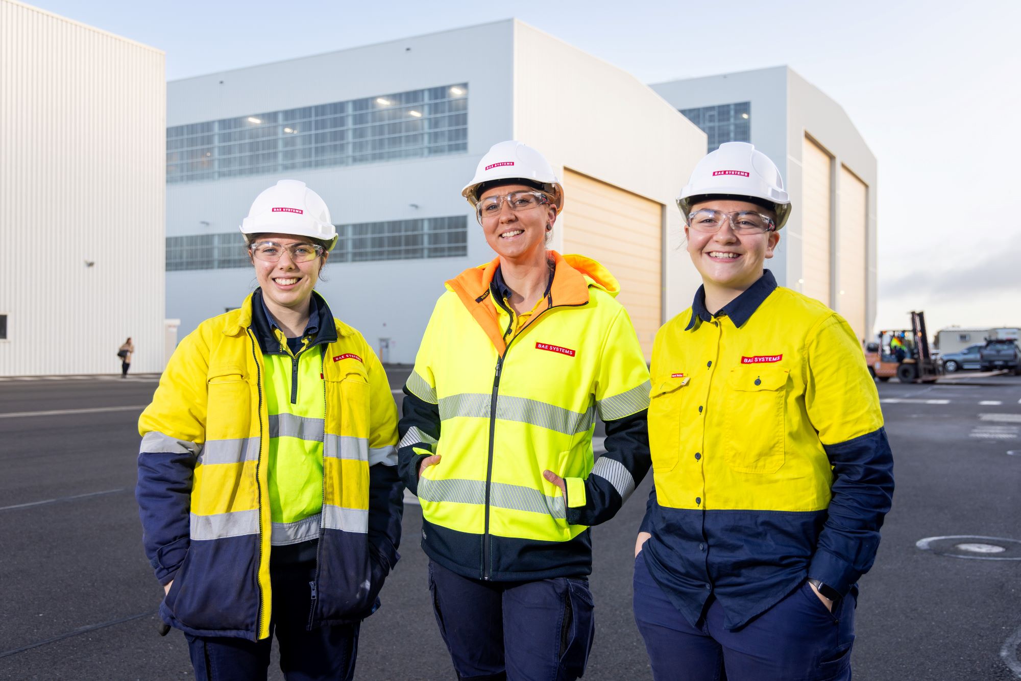 Apprentices Becky, Lexi & Mel smiling at the Osborne Naval Shipyard