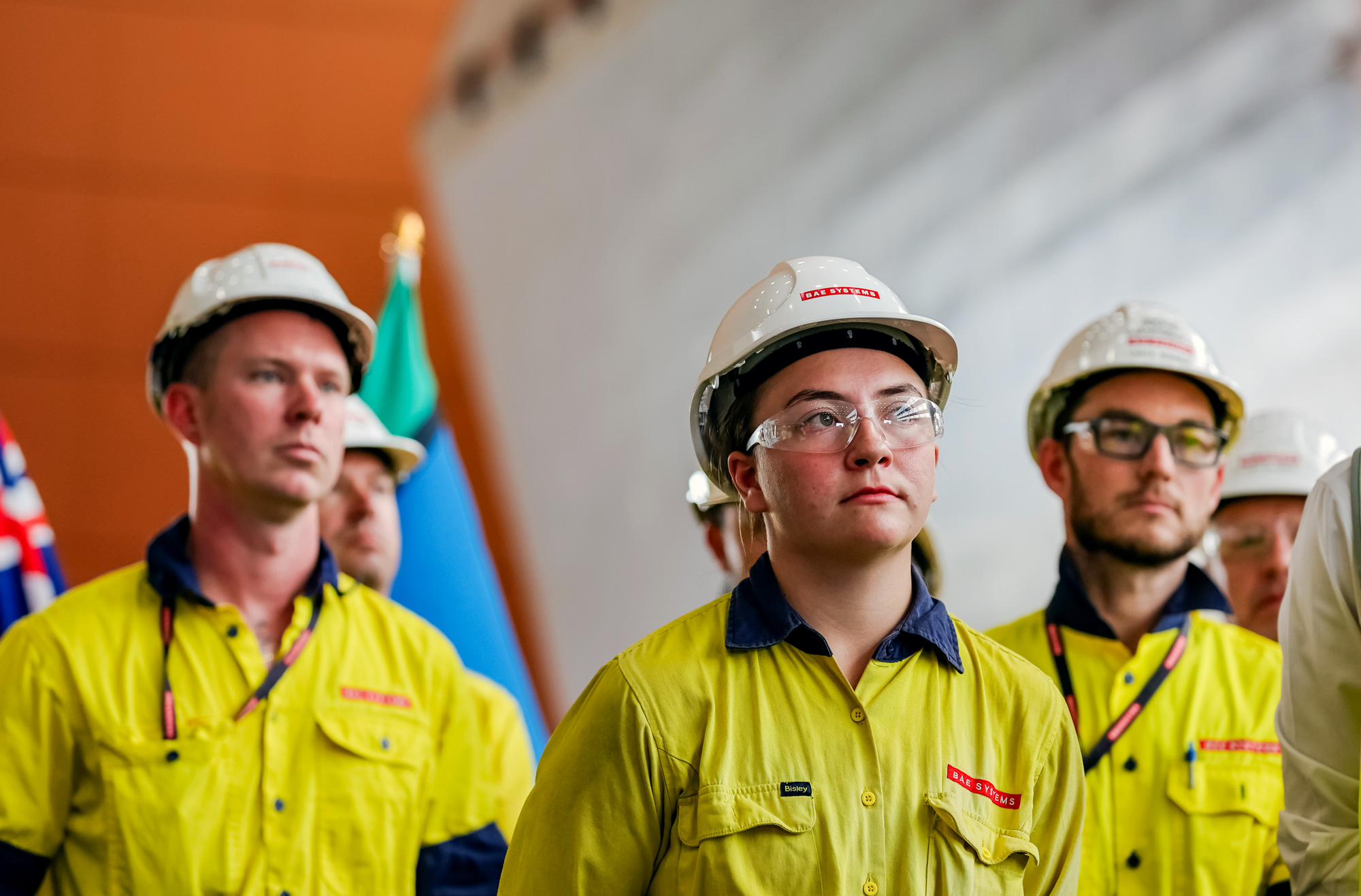 Close up of shipbuilders at Osborne Naval Shipyard wearing glasses and helmets