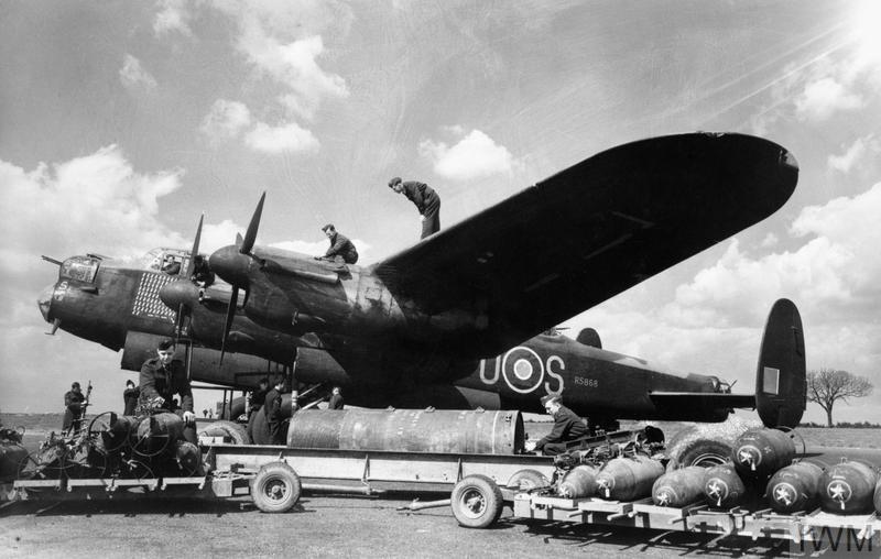 An Avro Lancaster pf the Royal Australian Air Force being loaded with bombs by ground crew