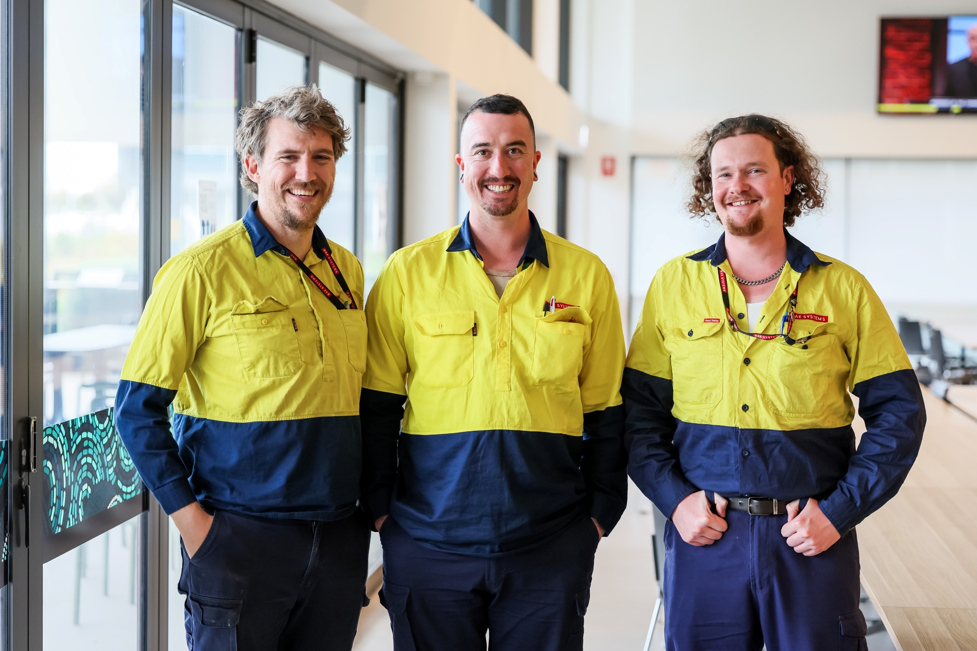 Three tradespeople in high-vis