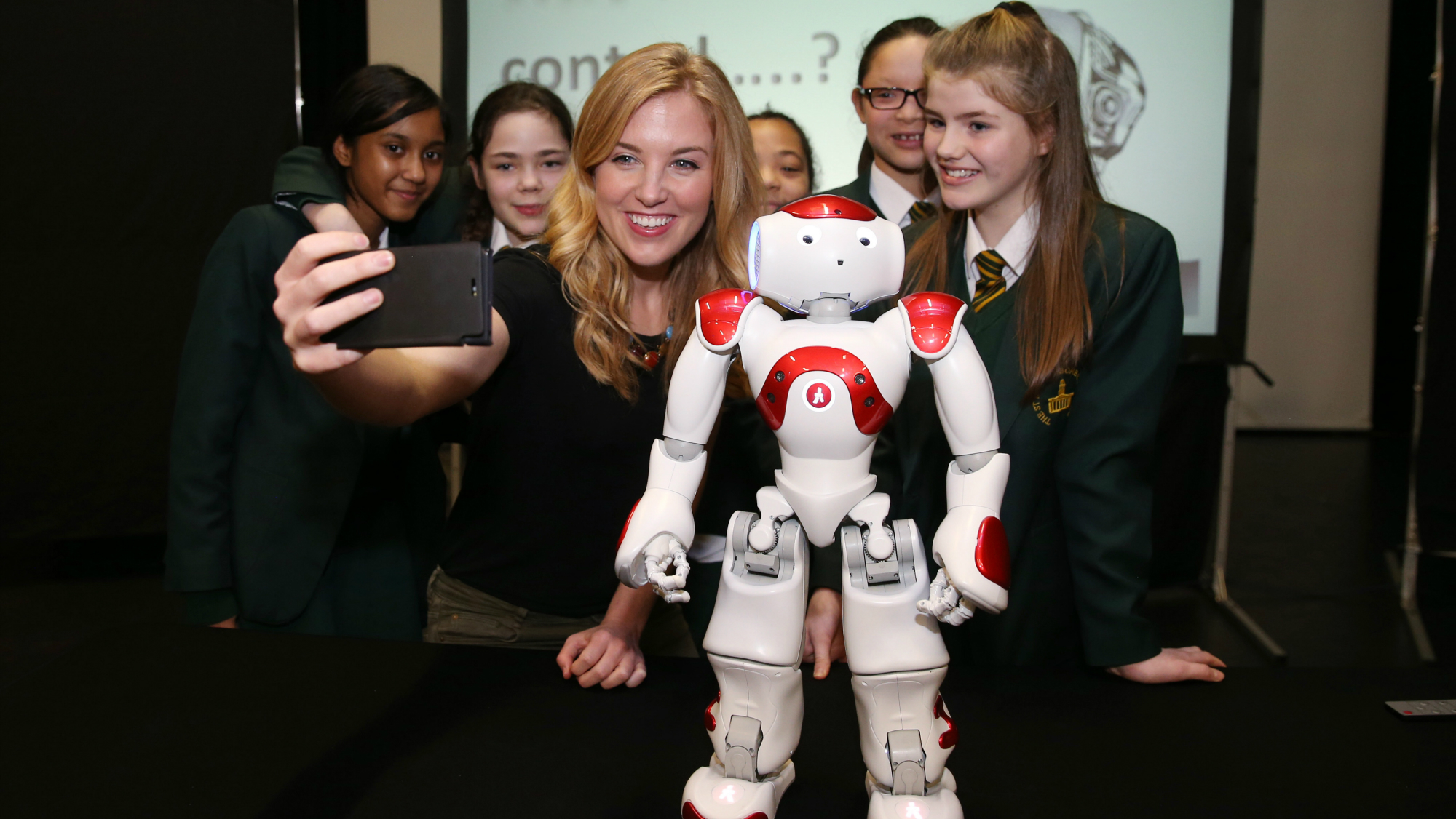 Image of Maddie Moate and students from St. Marylebone Church of England School, with Maya the robot!