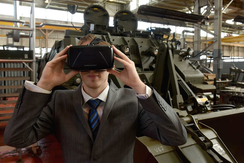 Employee tries on virtual reality headset