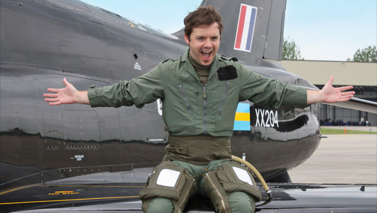 Blue Peter presenter Barney Harwood flies the flag