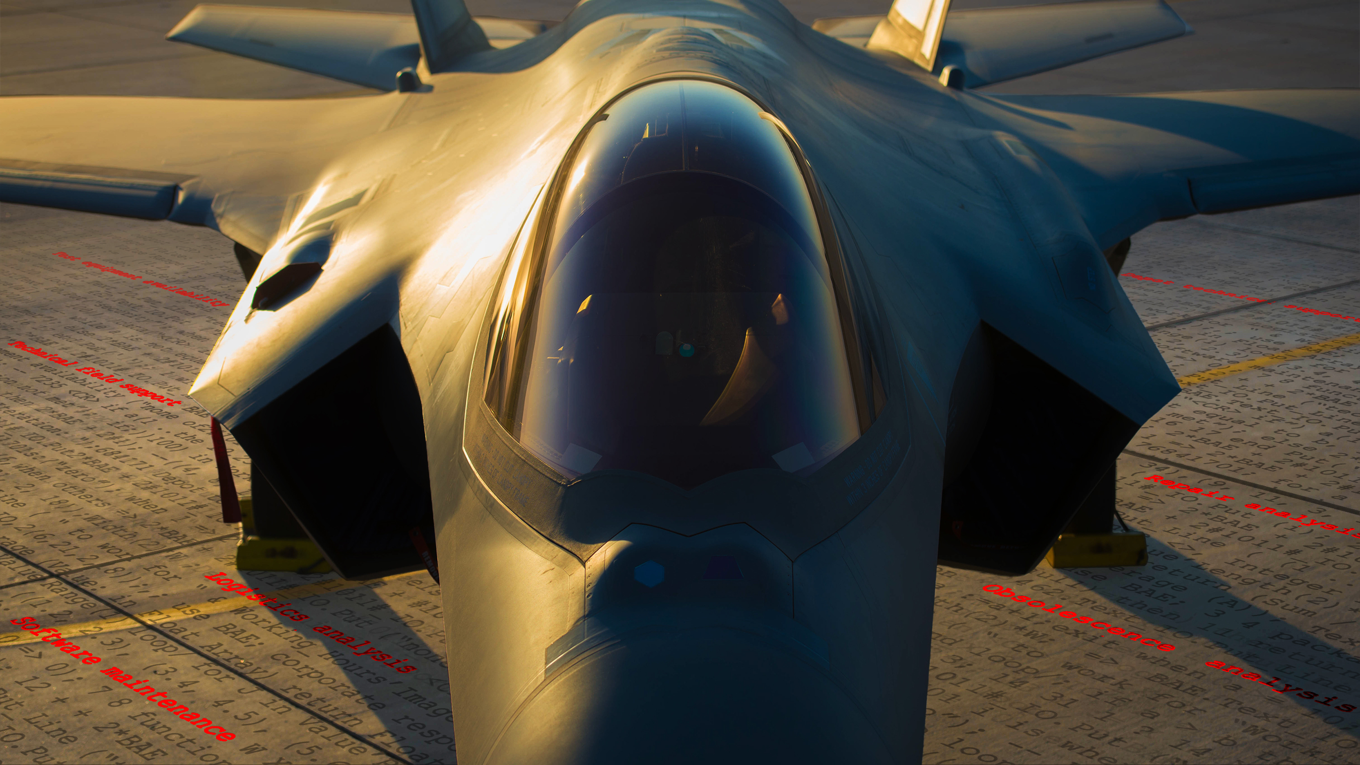 An F-35 Lightning II fighter aircraft sits on the ground. The ground is overlaid with software code.