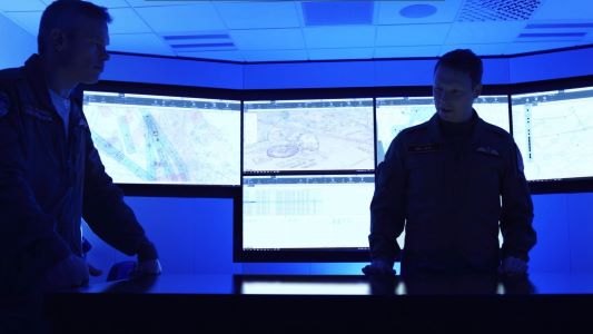 Two aircrew discuss a mission over Sceptre