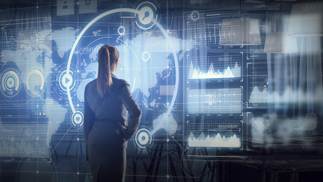 Woman at electronic performance dashboard, reflecting the vast amounts of data that our Resilient Ground Systems provide for better decision-making and more mission success.   