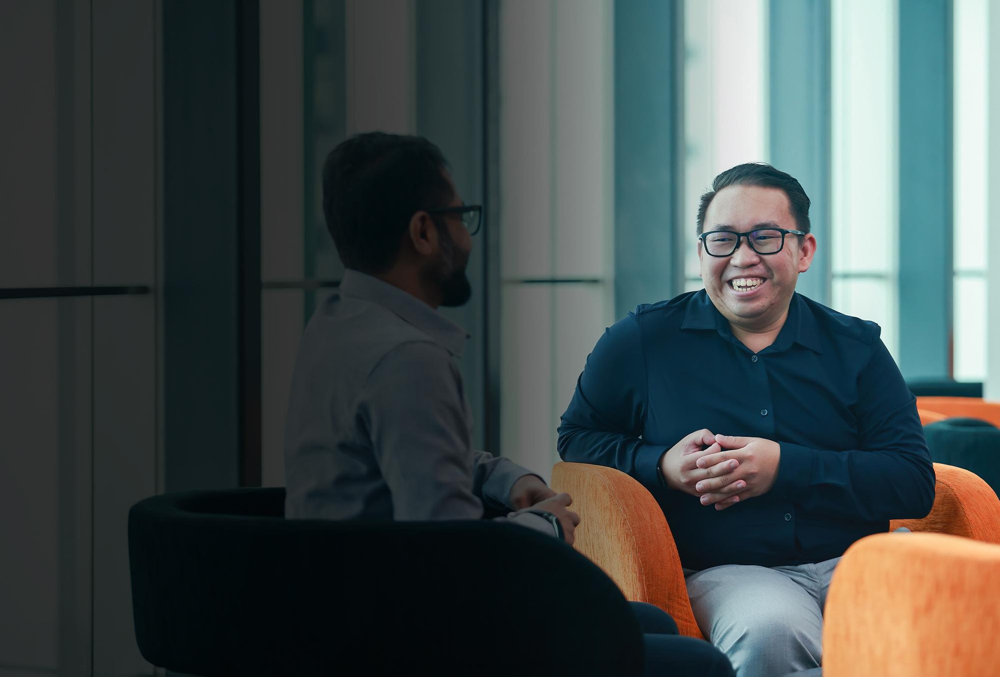 Man smiling at colleague