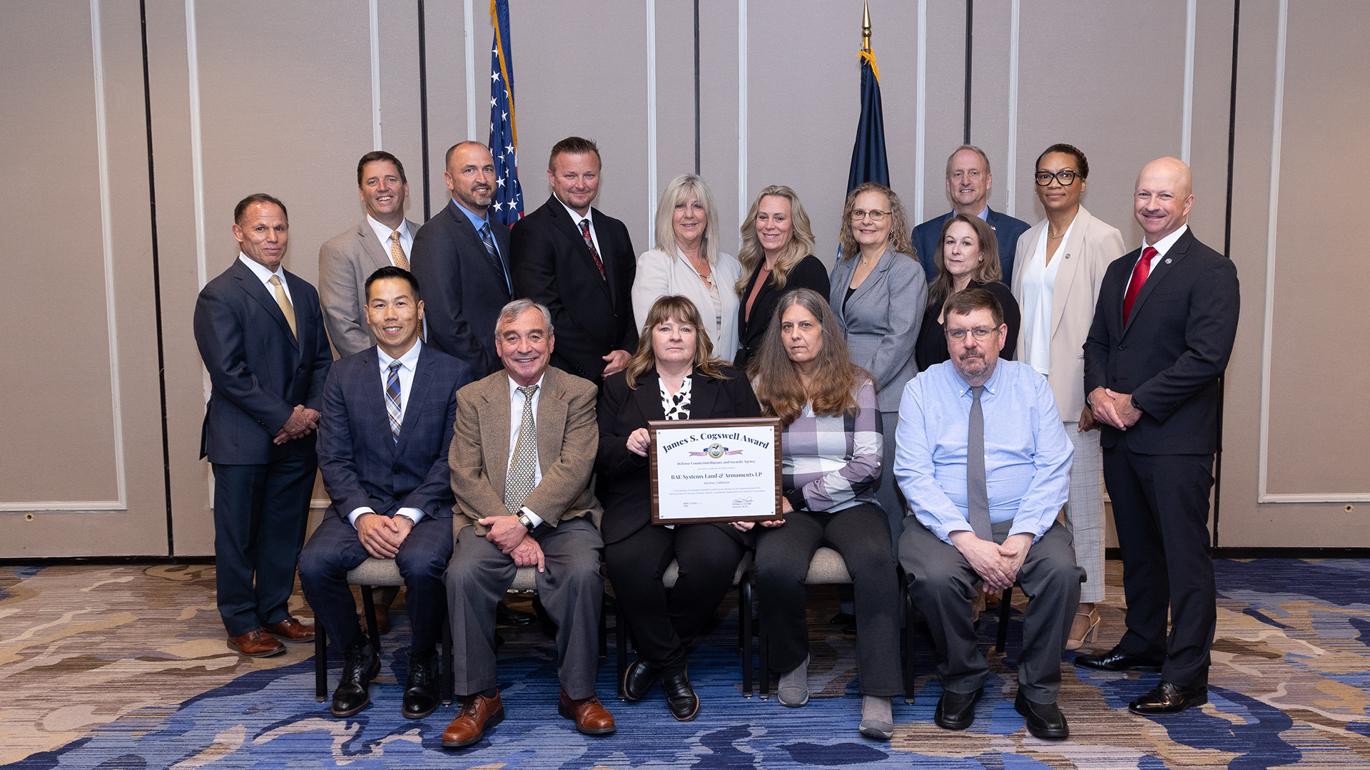 A group photo of San Jose facility employees standing together with their Cogswell Award in hand.